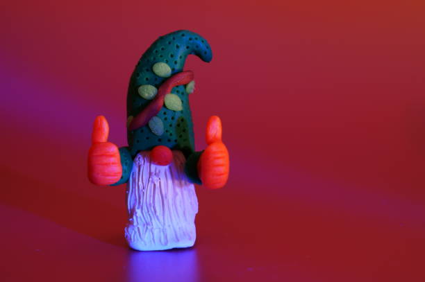 Clay doll of a smiling troll girl.