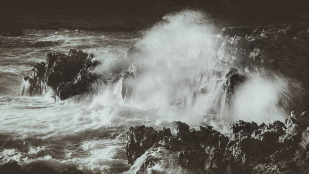 Photo of waves breaking on the rocks