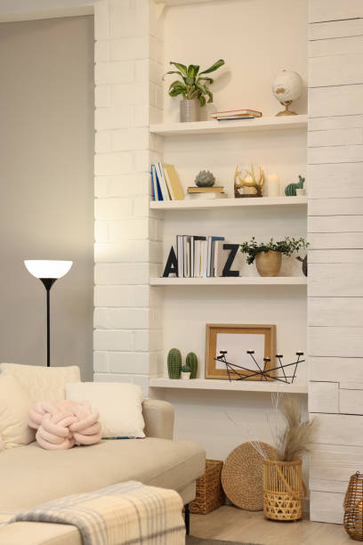 istock Sofa near shelves with different decor in room. Interior design 1434431991