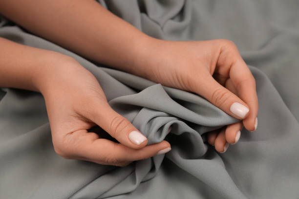 istock Woman touching smooth grey fabric, closeup view 1434432338