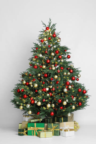 istock Beautiful Christmas tree and gift boxes on white background 1434432602