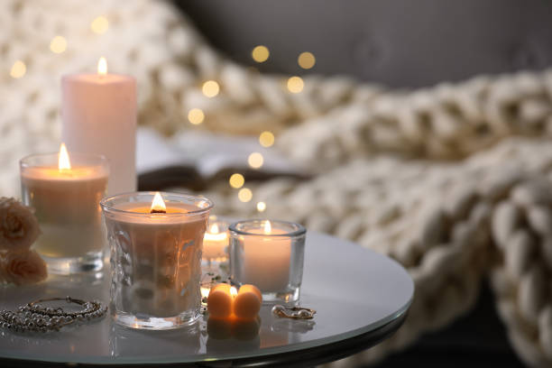 istock Burning candles and jewelry on table indoors 1434434430
