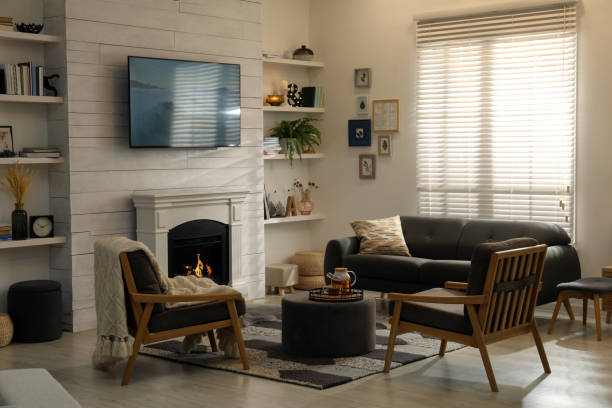 istock Cozy living room interior with comfortable sofa, armchairs and decorative fireplace 1434437127