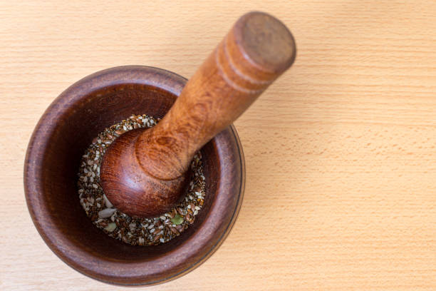 Top view wooden mortar, crushing various seeds