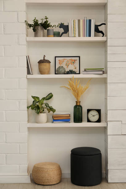 istock Beautiful green plants and different decor on shelves in room. Interior design 1434437380