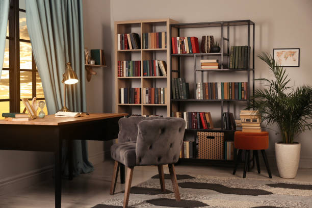 istock Cozy home library interior with collection of different books on shelves 1434437499