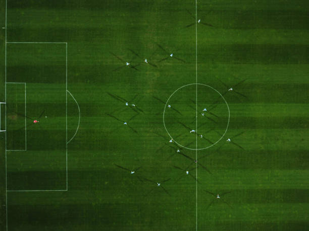 Aerial view of a football match, soccer. Football field and Footballers from drone stock photo