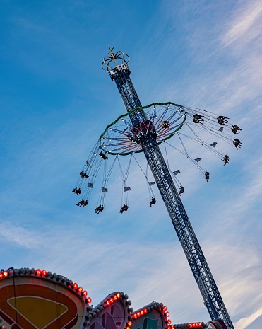 Vertical shot of a carousel at Munichs famous Beer Fest with blue sky, Munich, Germany