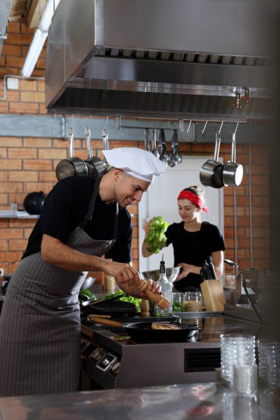 istock Professional chef cooking meat on stove in restaurant kitchen 1434440246