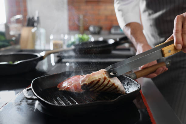 istock Professional chef cooking meat on stove in restaurant kitchen, closeup 1434440513