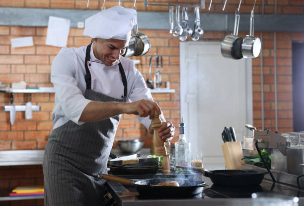 istock Professional chef cooking meat on stove in restaurant kitchen 1434440625