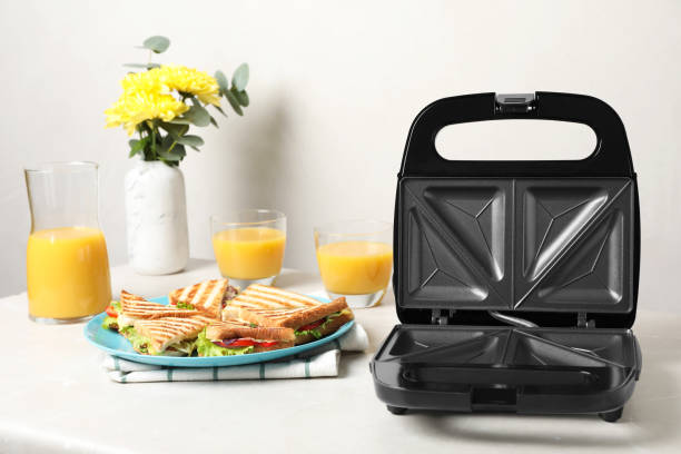istock Modern grill maker and sandwiches on white table 1434440799