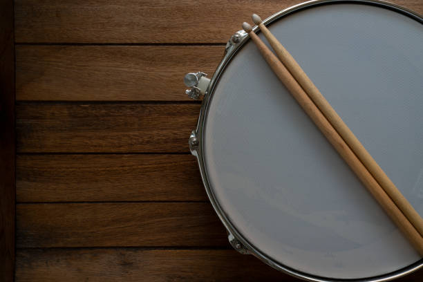 istock Drum stick and drum on wooden table background, top view, music concept 1434441437