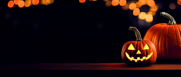 istock Cut out Halloween Pumpkin glowing at night with blurry lights in dark background 1434442637