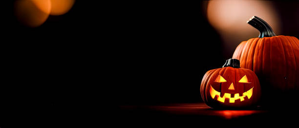 istock Cut out Halloween Pumpkin glowing at night with blurry lights in dark background 1434442673