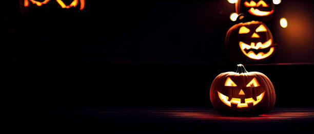 istock Cut out Halloween Pumpkin glowing at night with blurry lights in dark background 1434442763