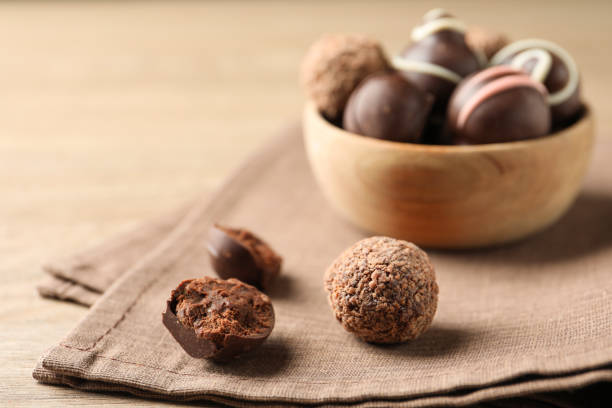 istock Different delicious chocolate truffles on wooden table 1434445134