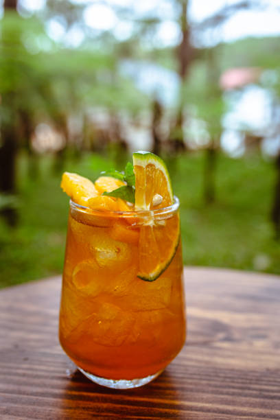 Mocktail Peach Ice Tea With Orange Juices, Lemongrass Drinking Glass High Resolution Stock Photo stock photo