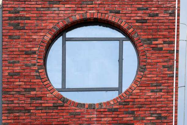 istock Closeup of round windows on red brick building 1434446148