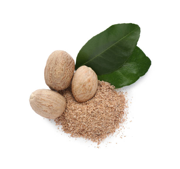 istock Nutmeg powder and seeds with green leaves on white background, top view 1434446801