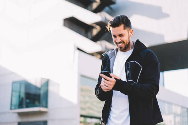 istock Happy male browsing phone preparing for jog in street 1434446866