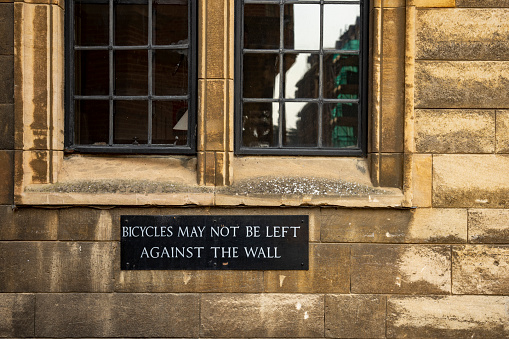 Warning sign on Kings College, Cambridge, Cambridgeshire, England, UK.