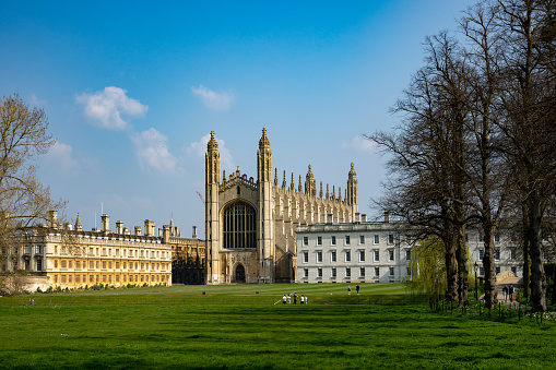 Kings College Chapel viewed through trees in springtime in the historic university town of Cambridge, England, UK.