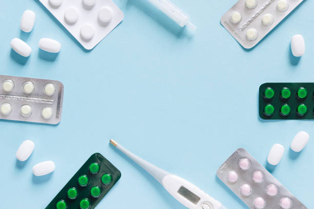 istock Scattered white pills on blue table. Mock up for special offers as advertising, web background or other ideas. Medical, pharmacy and healthcare concept. Copy space. Empty place for text or logo 1434449357