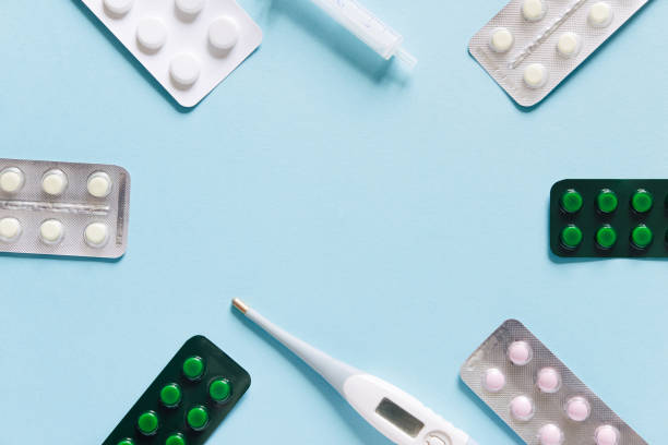 istock Scattered white pills on blue table. Mock up for special offers as advertising, web background or other ideas. Medical, pharmacy and healthcare concept. Copy space. Empty place for text or logo 1434449456