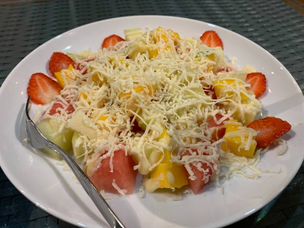 istock Fresh fruit salad with a sprinkling of grated cheese served on a plate 1434449846