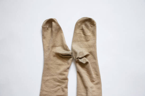 istock dirty brown womens long socks on white background, socks 1434450892