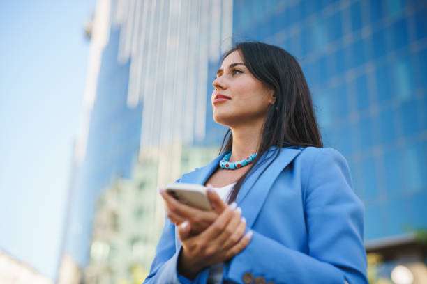 istock Businesswoman using mobile phone, financial district 1434450893