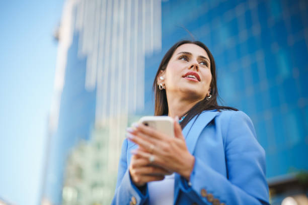 istock Businesswoman using mobile phone, financial district 1434450909