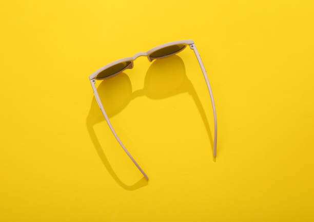 istock Top view stylish sunglasses on yellow bright background. 1434452204
