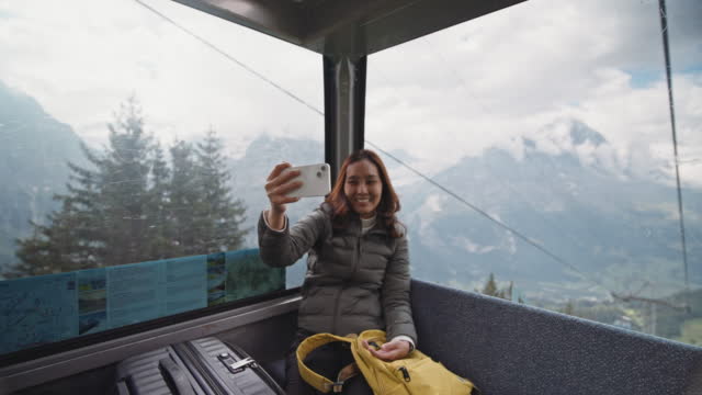 Tourist young woman selfie ropeway