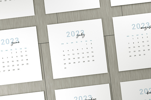 2023 July Calendar Pages On Wood Table. Time And Planning Concept.