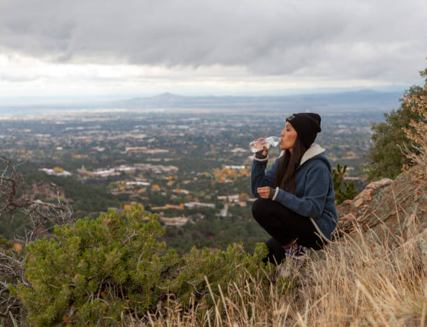 istock Woman drinking water on summit 1434462439