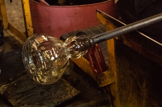 istock Glassblowing - rotating the glass object to shape it 1434462462