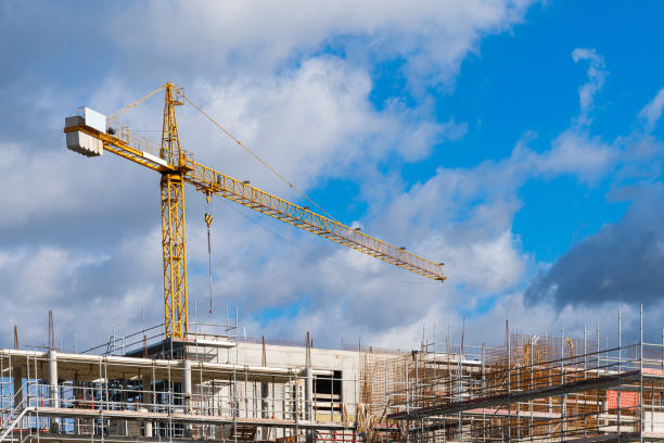 istock Tower crane over building under construction in scaffolding. 1434462478