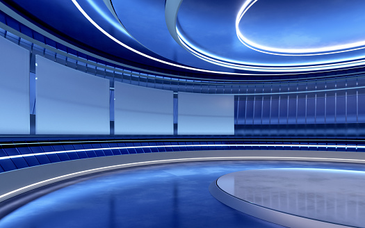 Virtual television studio with modern design, circular blue walls, reflecting surfaces, blank displays and bright illumination resembling a news broadcaster backdrop. Wide shot of empty studio with central stage illuminated by blue and white lights. Copy space.