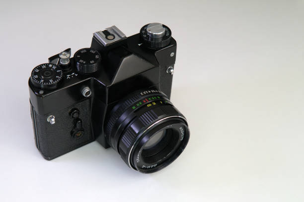 istock Old vintage SLR film camera standing on a white background, isolated 1434465643