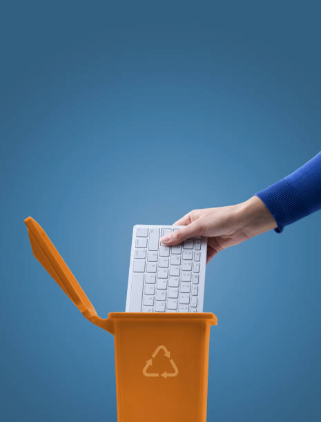 istock Woman putting a computer keyboard in the trash bin 1434466209