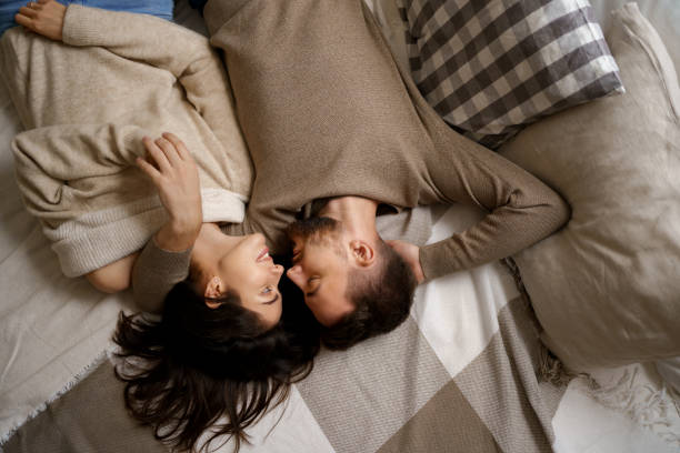 istock Beautiful couple lying on bed relaxing together 1434468123