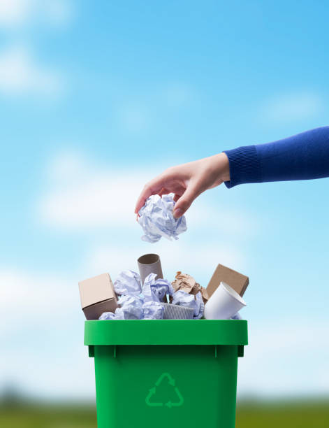 istock Woman putting paper in the waste bin 1434468146