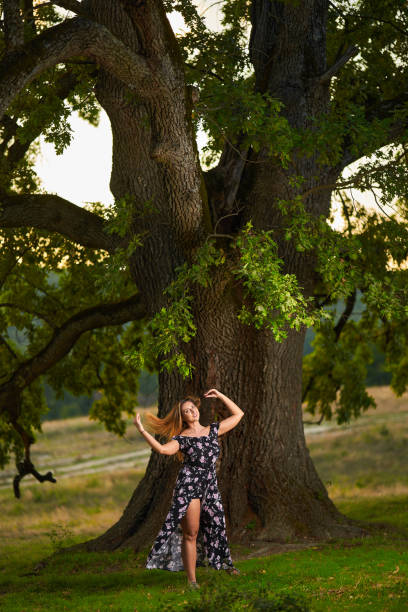 istock Young Indian plus size woman by a huge tree at sunset 1434469572
