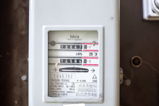 Valjevo, Serbia - August 24, 2021: Electric power meter measuring power usage. Watt hour electric meter measurement tool.