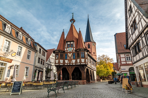 Michelstadt, Germany - OCTOBER 17, 2022: The old town-hall, built in the year 1484 in Michelstadt with beautiful coloured leaves in the background.