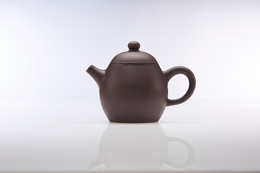 Tea cup, teapot and samovar on a dark background. Close-up, selective focus