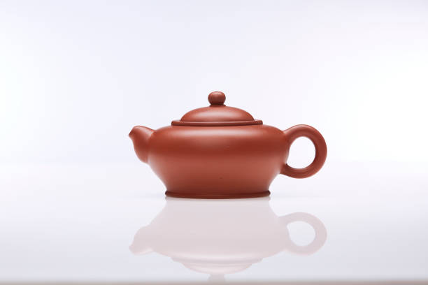istock Brown clay teapot on white white background, studio shot. 1434471612