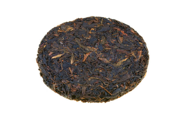 Black pu-erh Chinese tea. Pressed tiles of fermented black tea isolated on white background